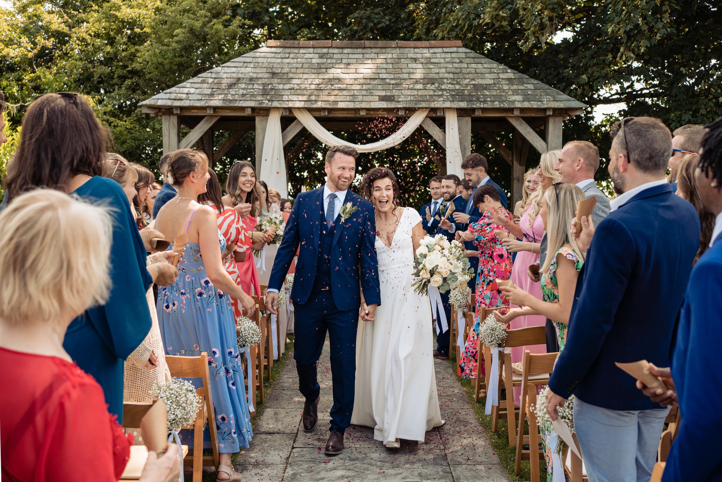 wedding couple walking down aisle at trevenna barns cornwall
